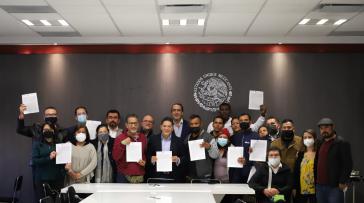 Migranten und Regierungsvertreter unterzeichnen die Vereinbarung in Mexiko-Stadt
